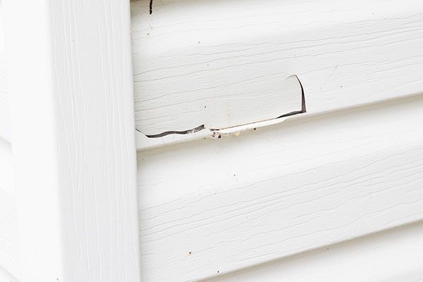 Damaged white siding is an ideal candidate for Hardieplank siding.
